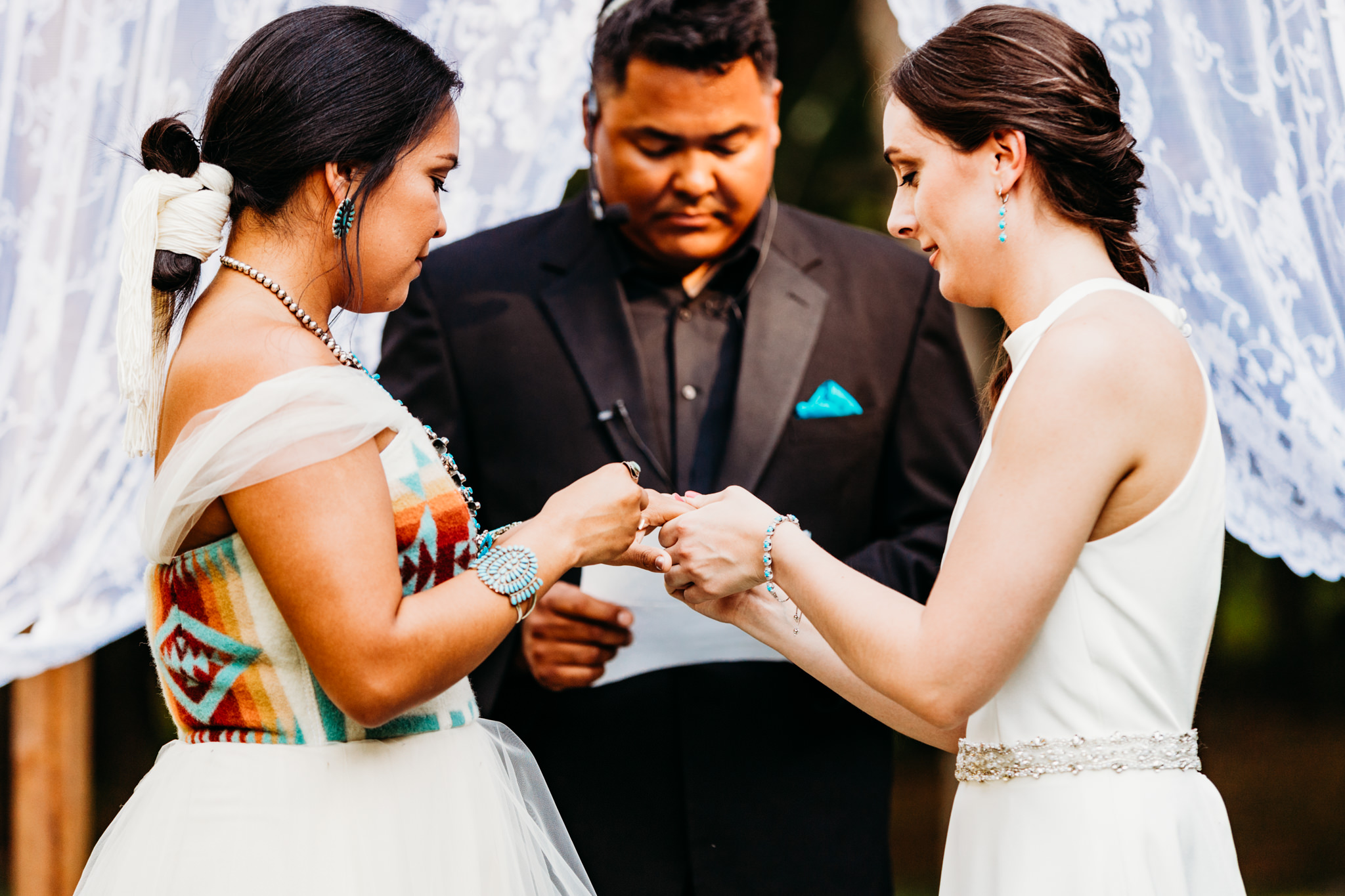 brides exchange rings at their native-inspired wedding