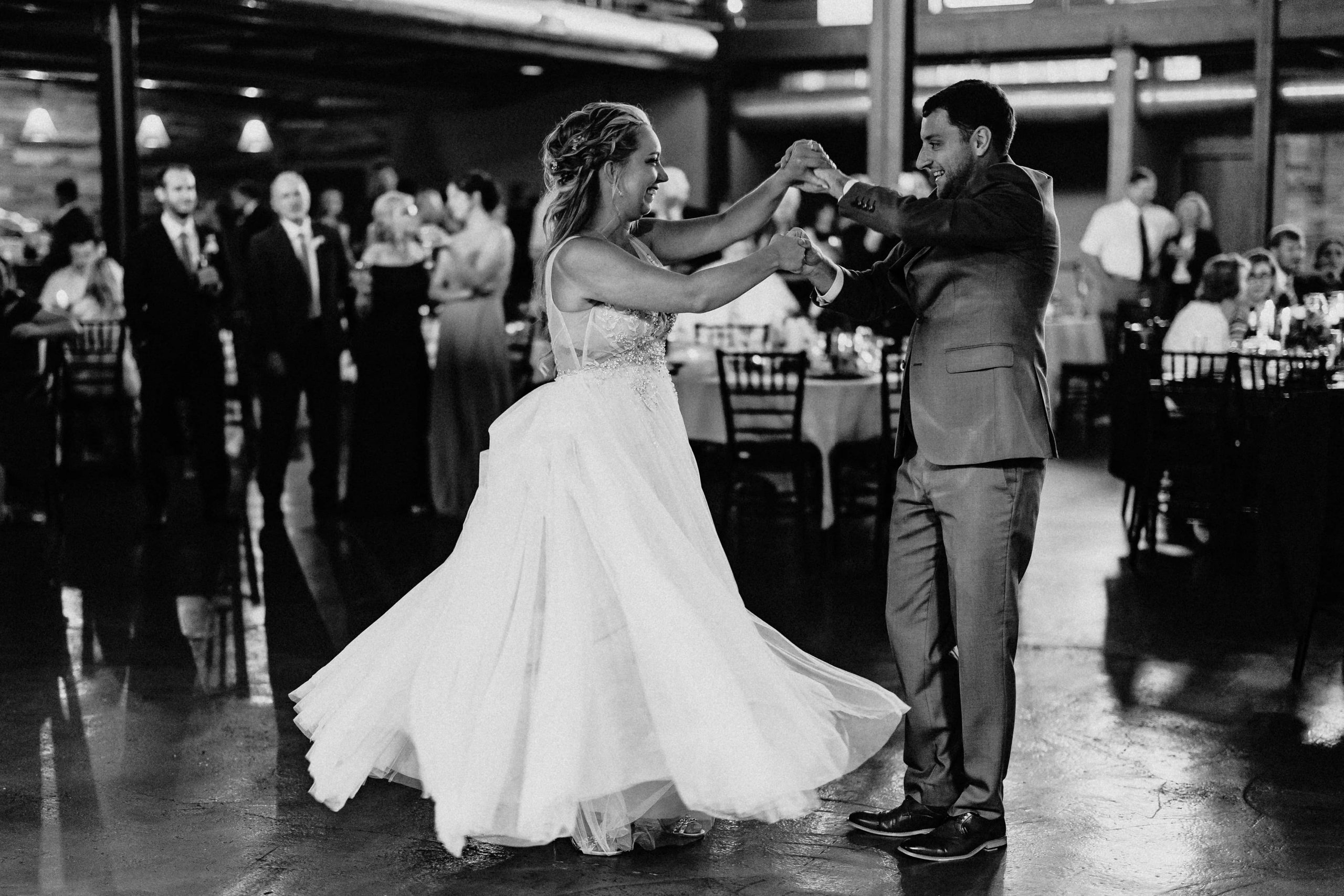 Bride and groom dancing in a black and white photo at their Duluth Malting Building Wedding