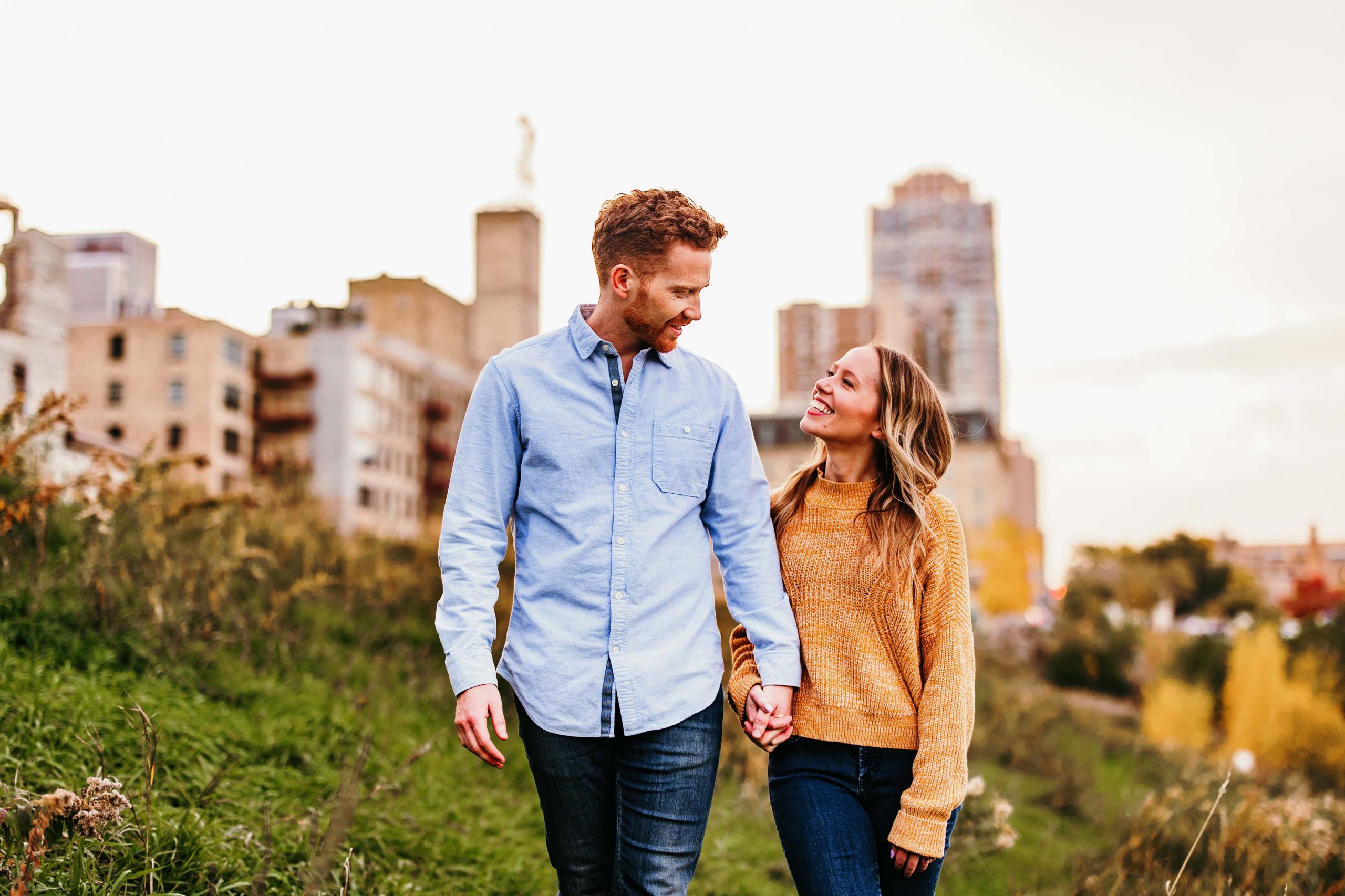 Couple smile at each other during their Mill Ruins Park engagement photoshoot