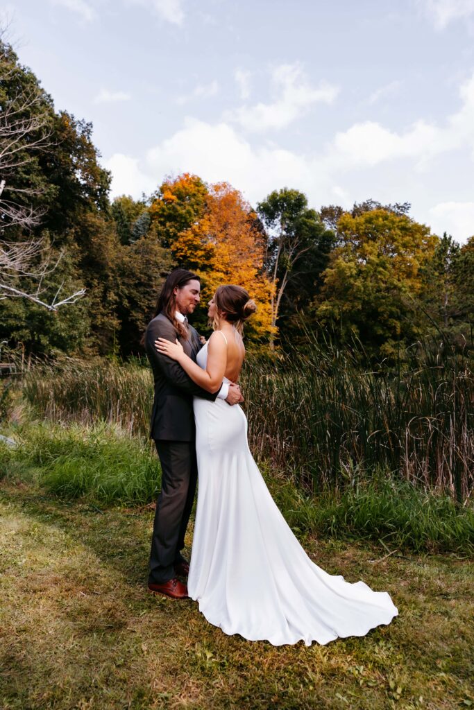 Outside Minnesota wedding venues a bride and groom hold each other