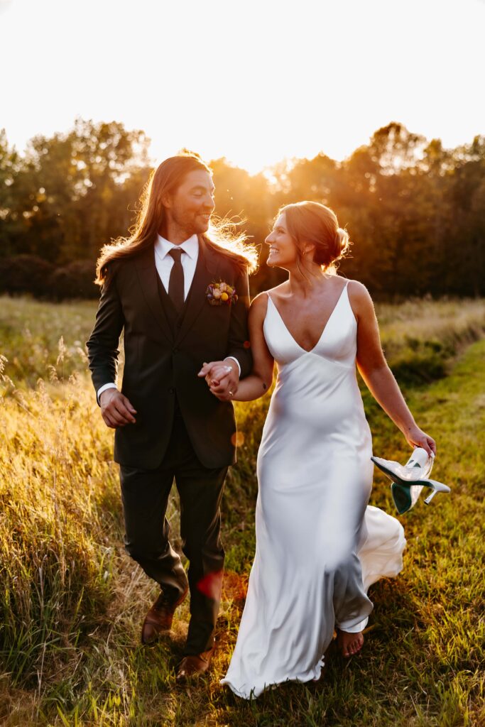 Bride and groom laugh at sunset at their choice of Minnesota wedding venues