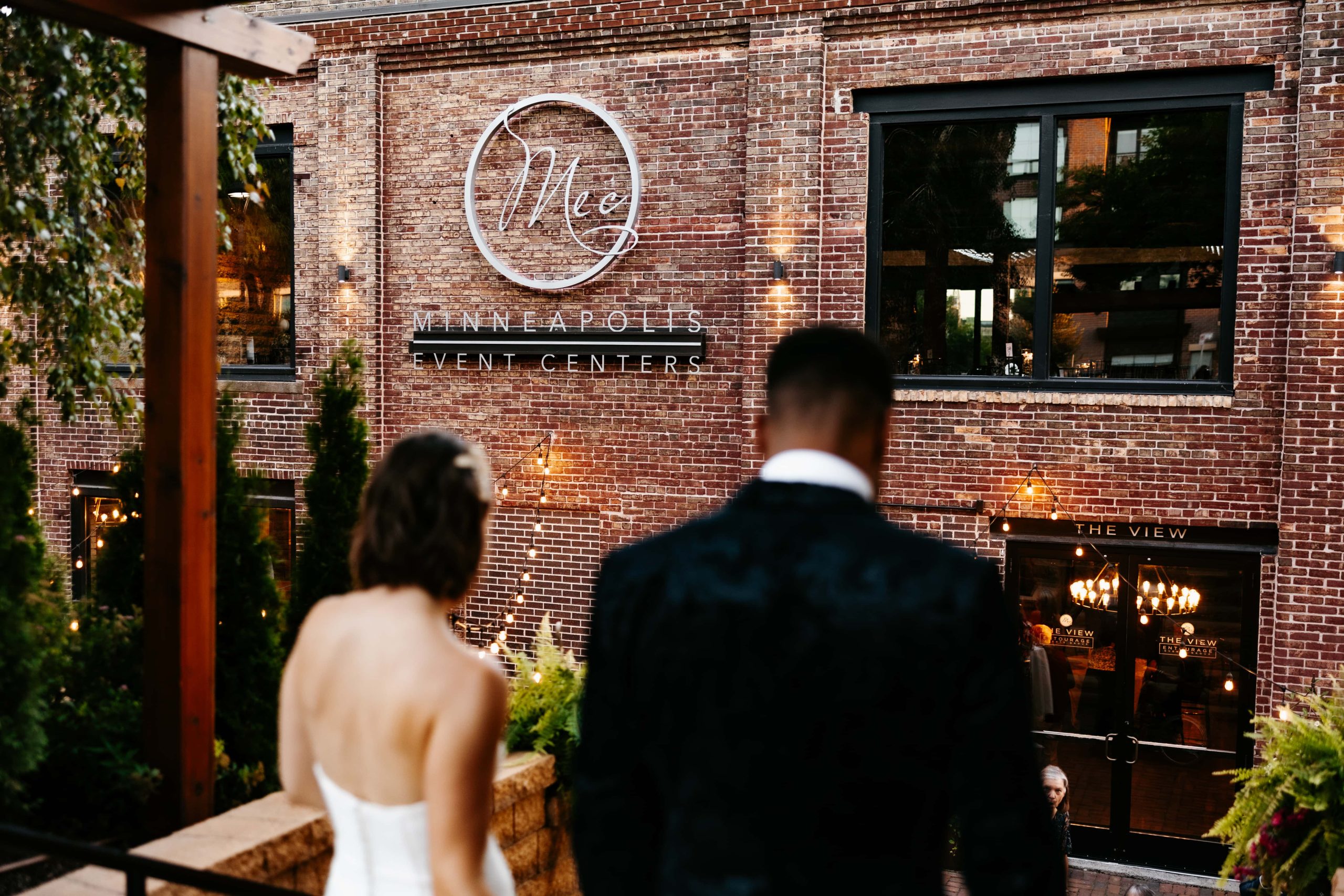 Minneapolis wedding photographer shows couple walking back to their minneapolis wedding