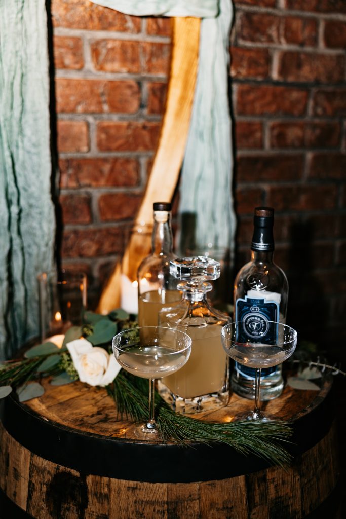 Drinks and glasses are displayed on a bottle at a tattersall event center wedding 