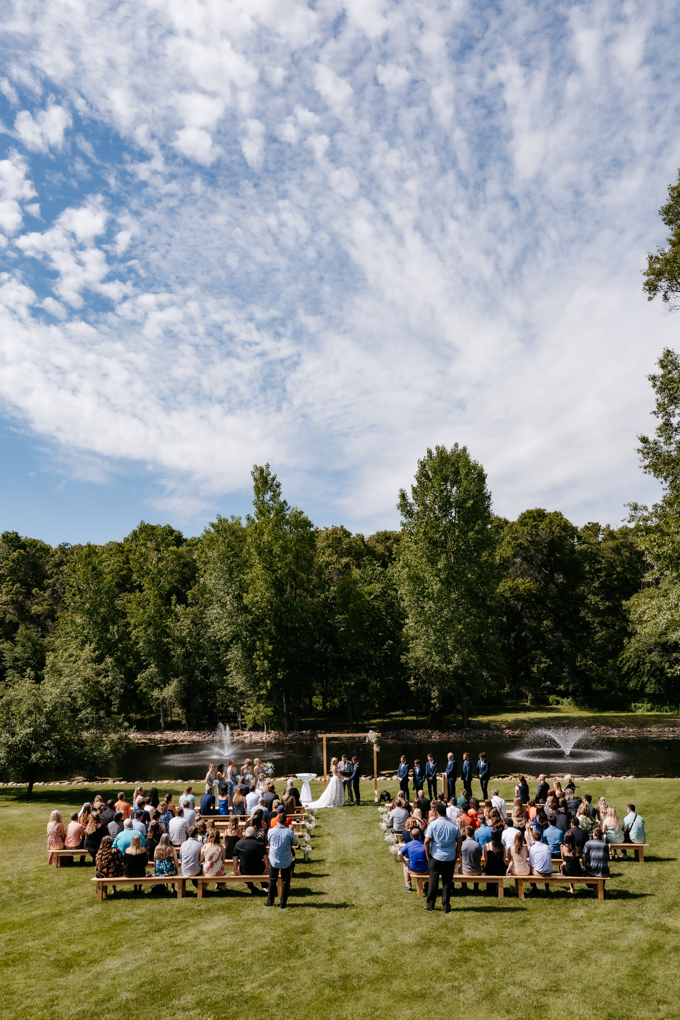 Wide view of the ceremony space along the water at Northern Oaks Events wedding