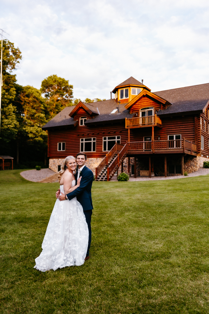 Couple smiles at golden hour outside the cabin at their northern oaks events wedding