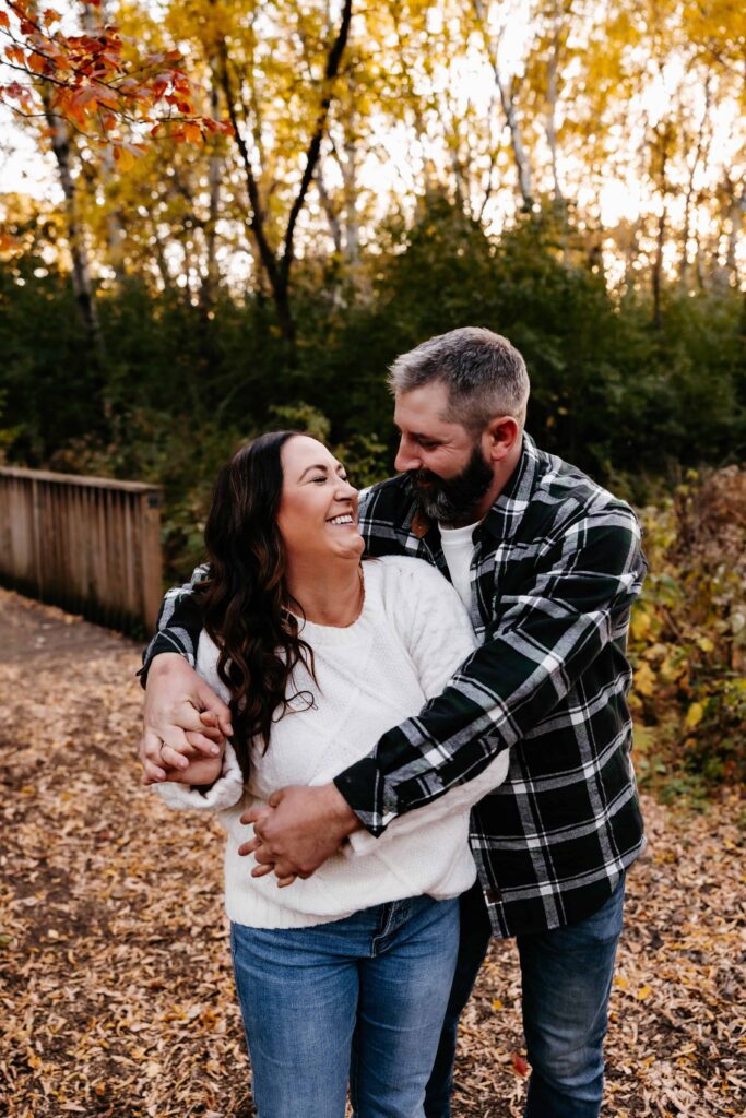 a man and woman hugging outside