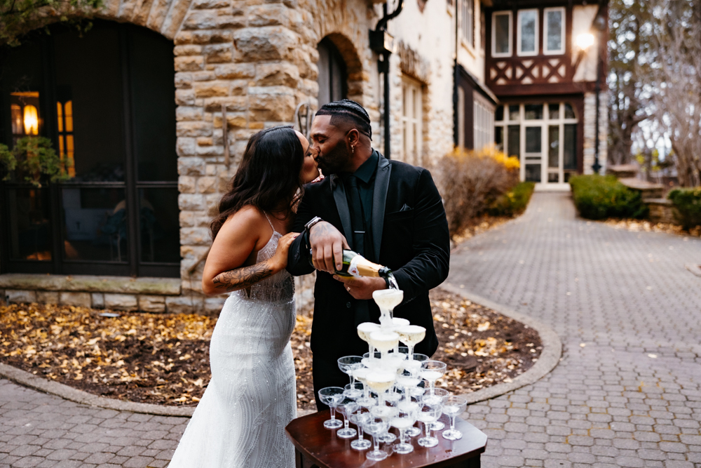 a man and woman kissing outside of Rochester MN wedding venue