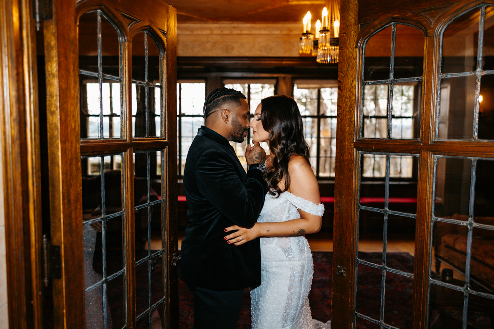 a man and woman kissing in a doorway at rochester mn wedding venue