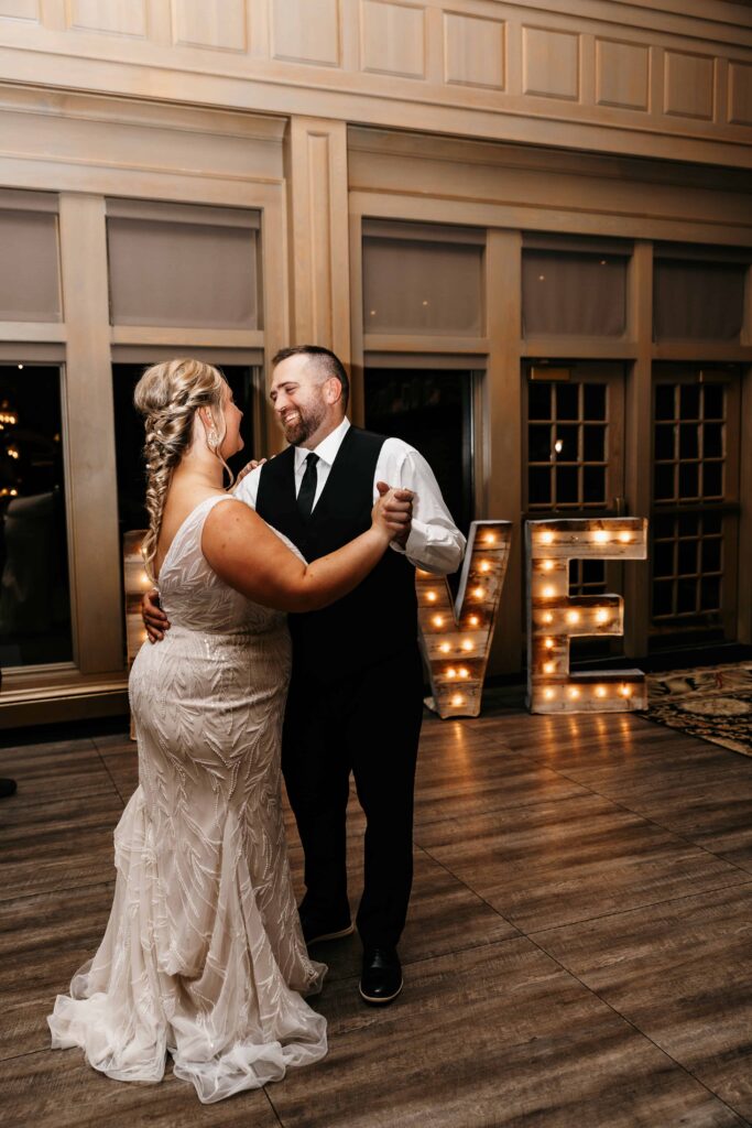 Bride and groom have first dance inside the ballroom at their Rush Creek Golf Club wedding