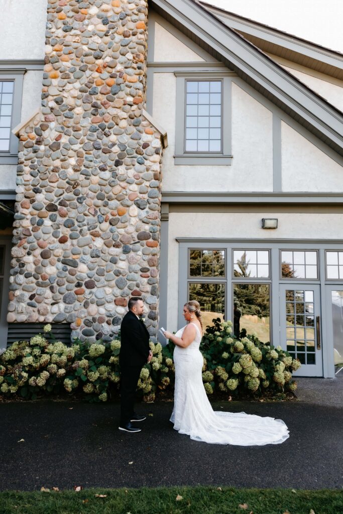 Bride and groom exchange vows outside ballroom at their rush creek golf club wedding