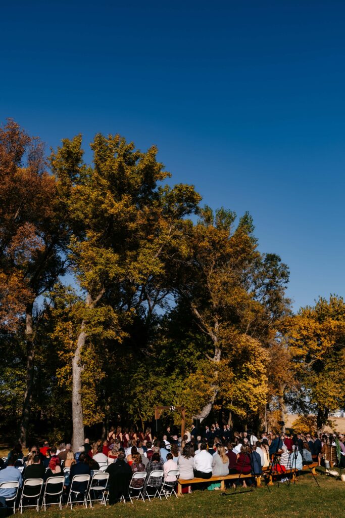 Wedding ceremony takes place on the lawn at Schroeder Farms with Nic as their Mankato Wedding Photographer