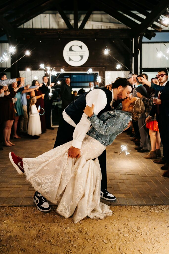 Couple kiss outside of Schroeder Farms with Mankato Wedding photographer