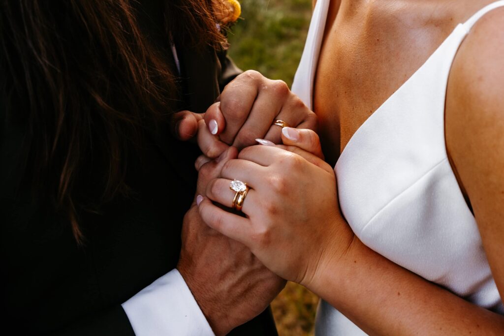 Bride and groom hold hands at their st .cloud wedding.